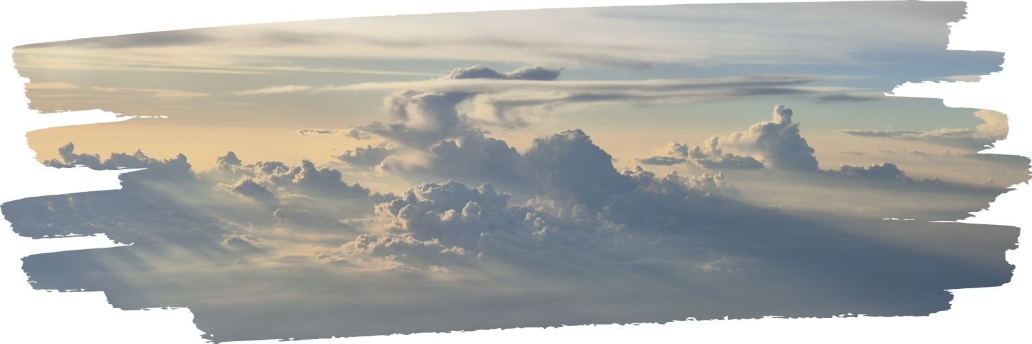 A breathtaking sunset viewed from an airplane window, with warm orange and pink hues painting the sky above the clouds.