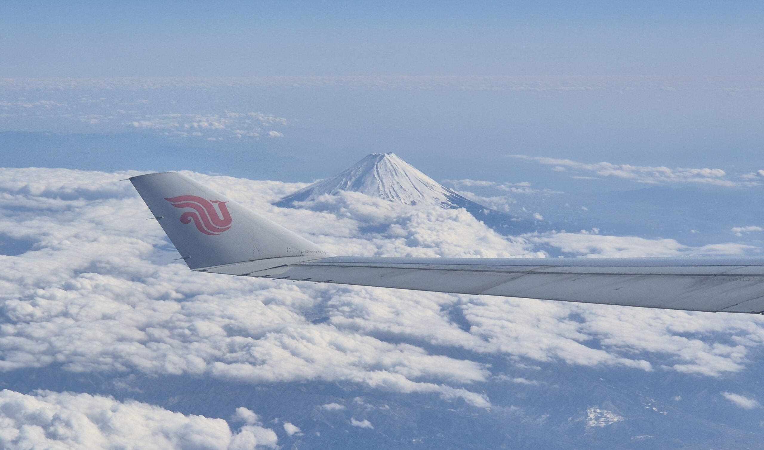 Mount Fuji aerial view from Air China airplane window on a clear day, Japan travel inspiration
